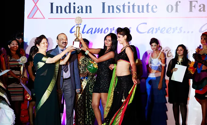 A picture IIFT Fashion Design Students Holding Trophy Along With Director of IIFT Late Mr. B. Vedhagiri